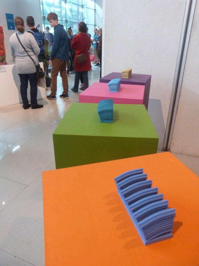 Iridescence: five 3D print outs of photonics structures from the butterfly Morpho aurora on coloured plinths.